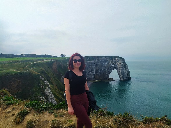 A person standing on a hill by a body of water

Description automatically generated with medium confidence