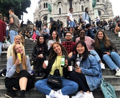 A group of people sitting on steps

Description automatically generated with low confidence